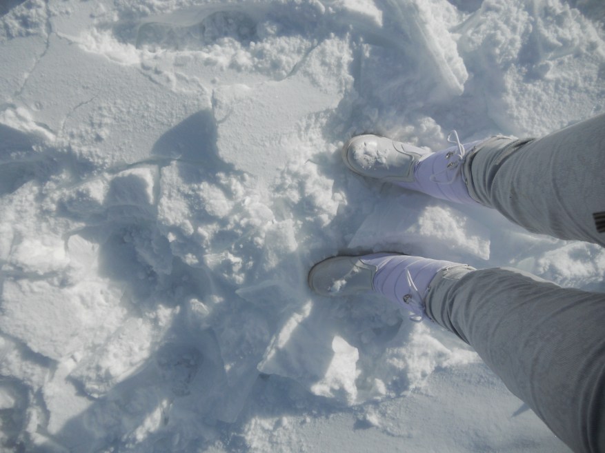 guess winter boots on the snow